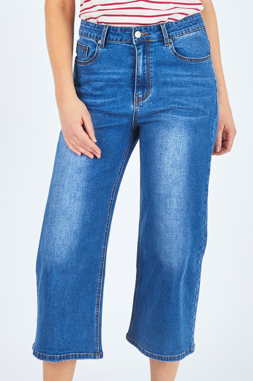 Model Chelsea wearing size 10 of The Wide Leg Jean in colour Denim (Blue), from the front, cropped image