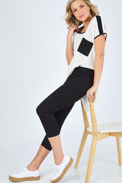 Model Chelsea wearing size 10 of The Cropped Skinny Pull On Jean in colour Black (Black), from the front, showing the whole outfit