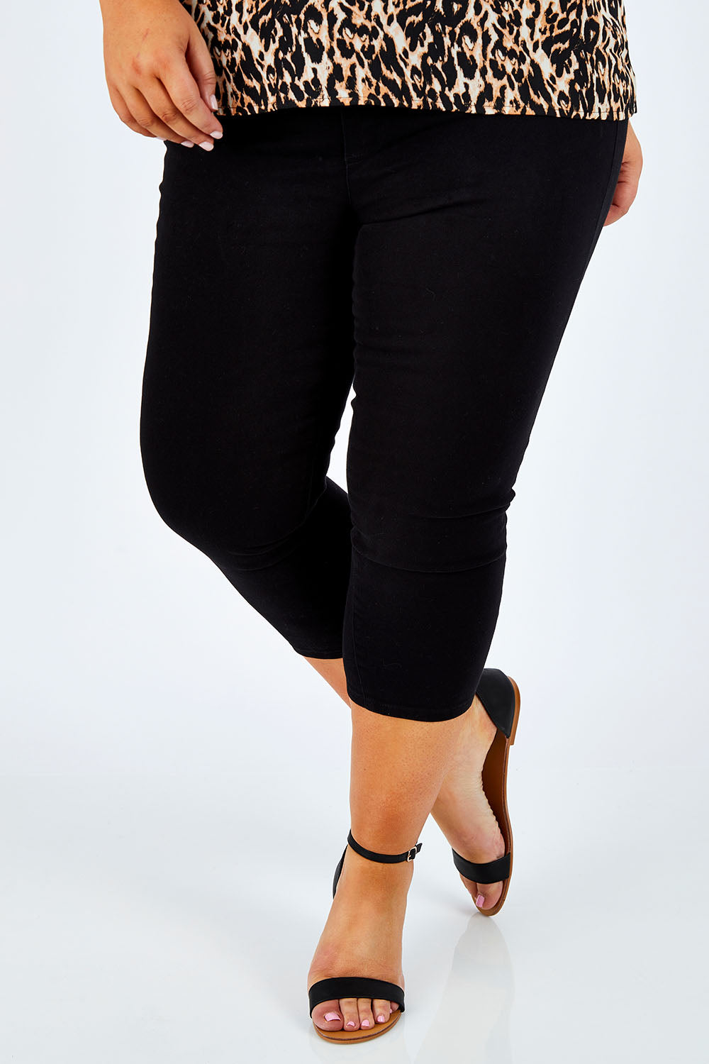 Model Stacey wearing size 16 of The Cropped Skinny Pull On Jean in colour Black (Black), from the front, cropped image