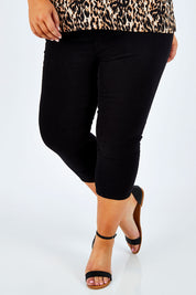 Model Stacey wearing size 16 of The Cropped Skinny Pull On Jean in colour Black (Black), from the front, cropped image