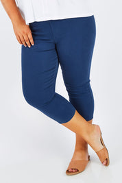 Model Stacey wearing size 16 of The Cropped Skinny Pull On Jean in colour Blue (Blue), from the front, cropped image