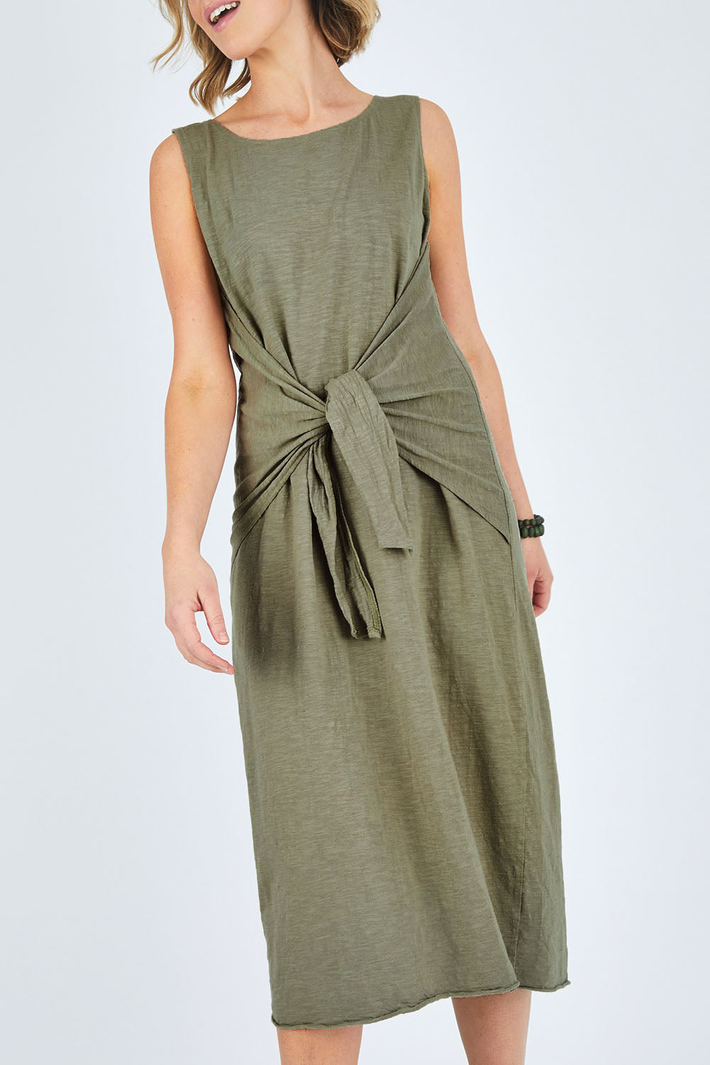 Model Chelsea wearing size 10 of The Tie Waist Tank Dress in colour Khaki (Green), from the front, cropped image