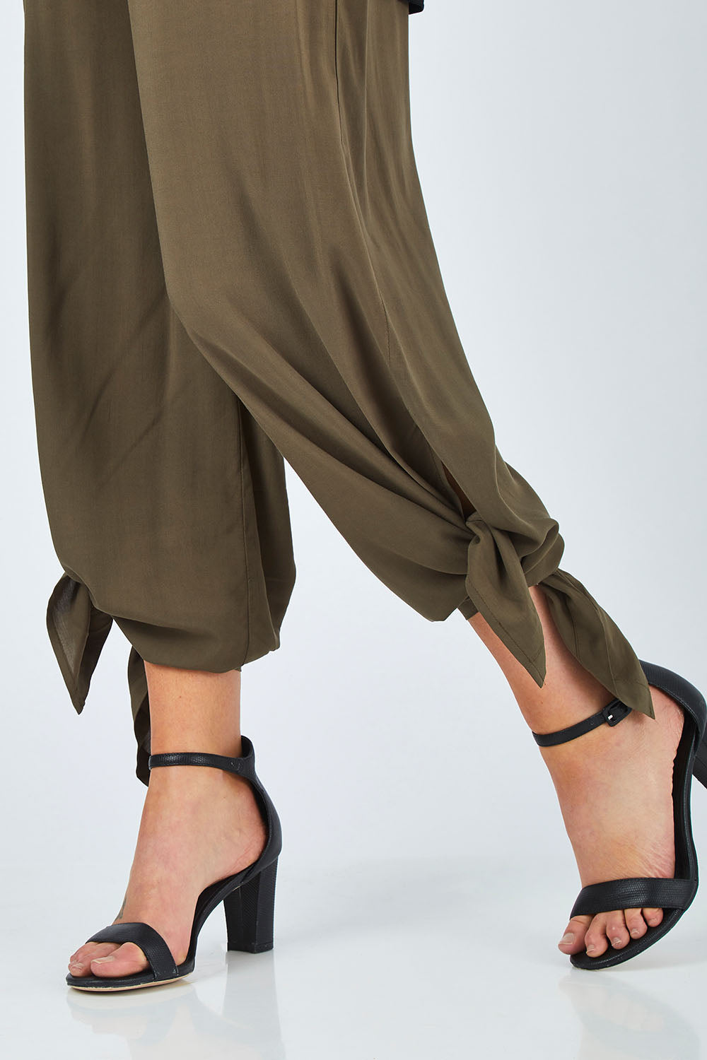 Model Chelsea wearing size 10 of The Tie Split Pull On Pant in colour Khaki (Green), from the front, cropped image