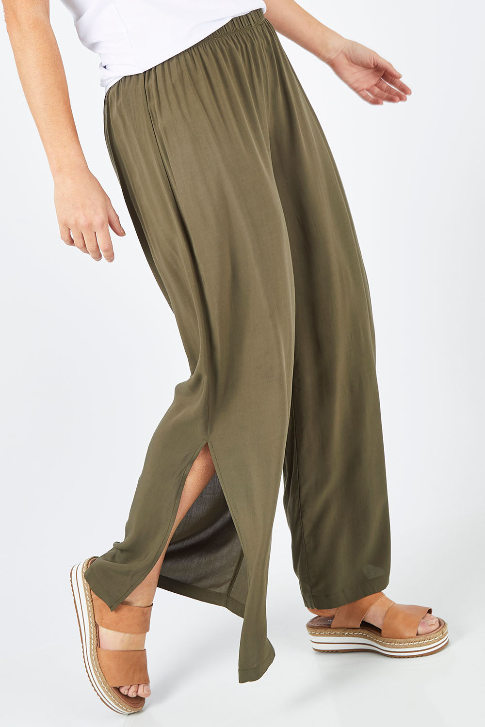 Model Laura wearing size 14 of The Tie Split Pull On Pant in colour Khaki (Green), from the front, cropped image