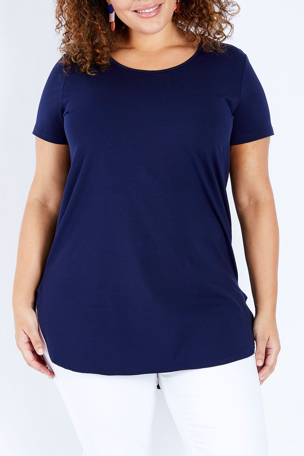 Model Jess wearing size 16 of The Boyfriend Tunic Tee in colour Navy (Blue), from the front, cropped image
