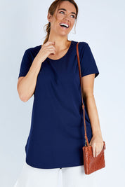 Model Laura wearing size 14 of The Boyfriend Tunic Tee in colour Navy (Blue), from the front, cropped image