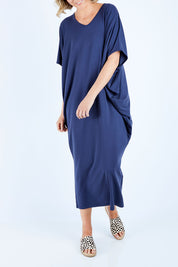 Model Chelsea wearing size 10 of The Midi Bamboo Dress in colour Navy (Blue), from the front, cropped image