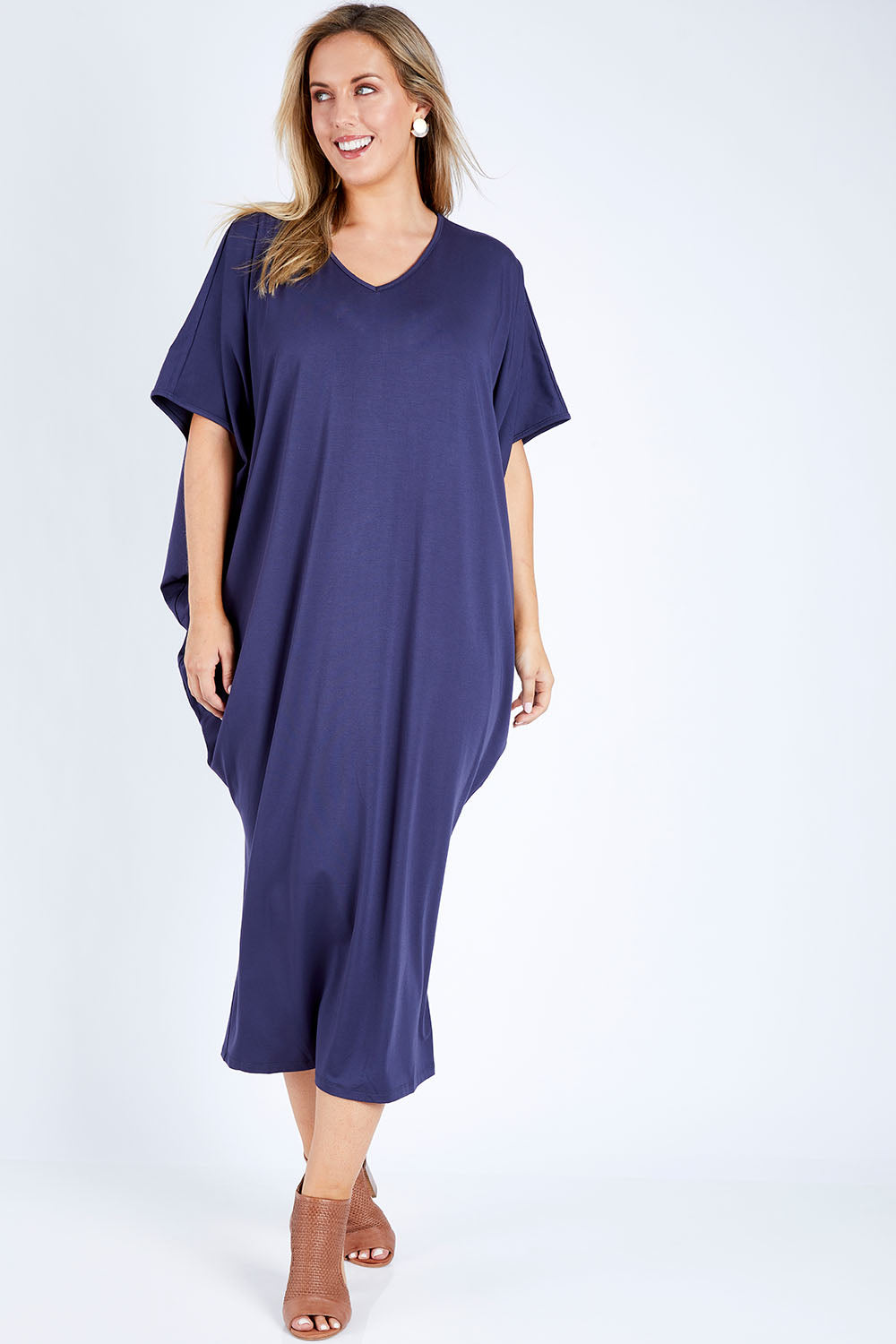 Model Jess wearing size 14 of The Midi Bamboo Dress in colour Navy (Blue), from the front, showing the whole outfit