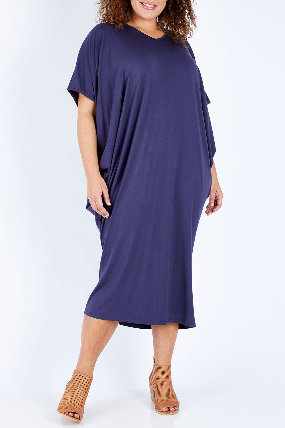 Model Jess wearing size 16 of The Midi Bamboo Dress in colour Navy (Blue), from the front, cropped image