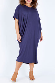 Model Jess wearing size 16 of The Midi Bamboo Dress in colour Navy (Blue), from the front, cropped image