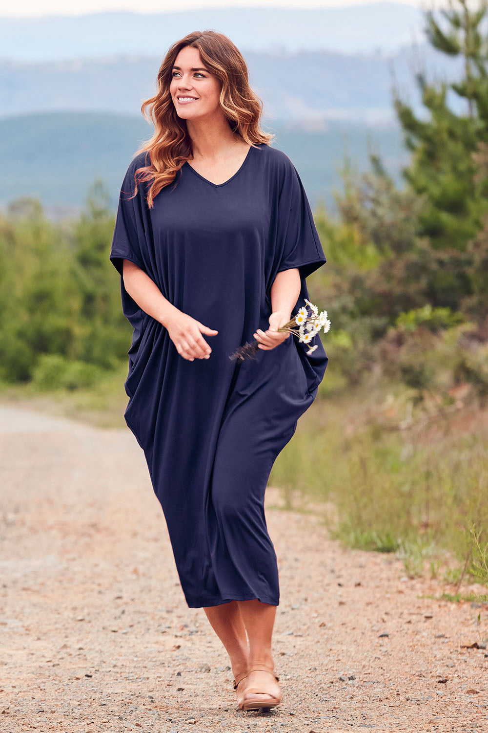 Model Laura wearing size 14 of The Midi Bamboo Dress in colour Navy (Blue), from the front, showing the whole outfit