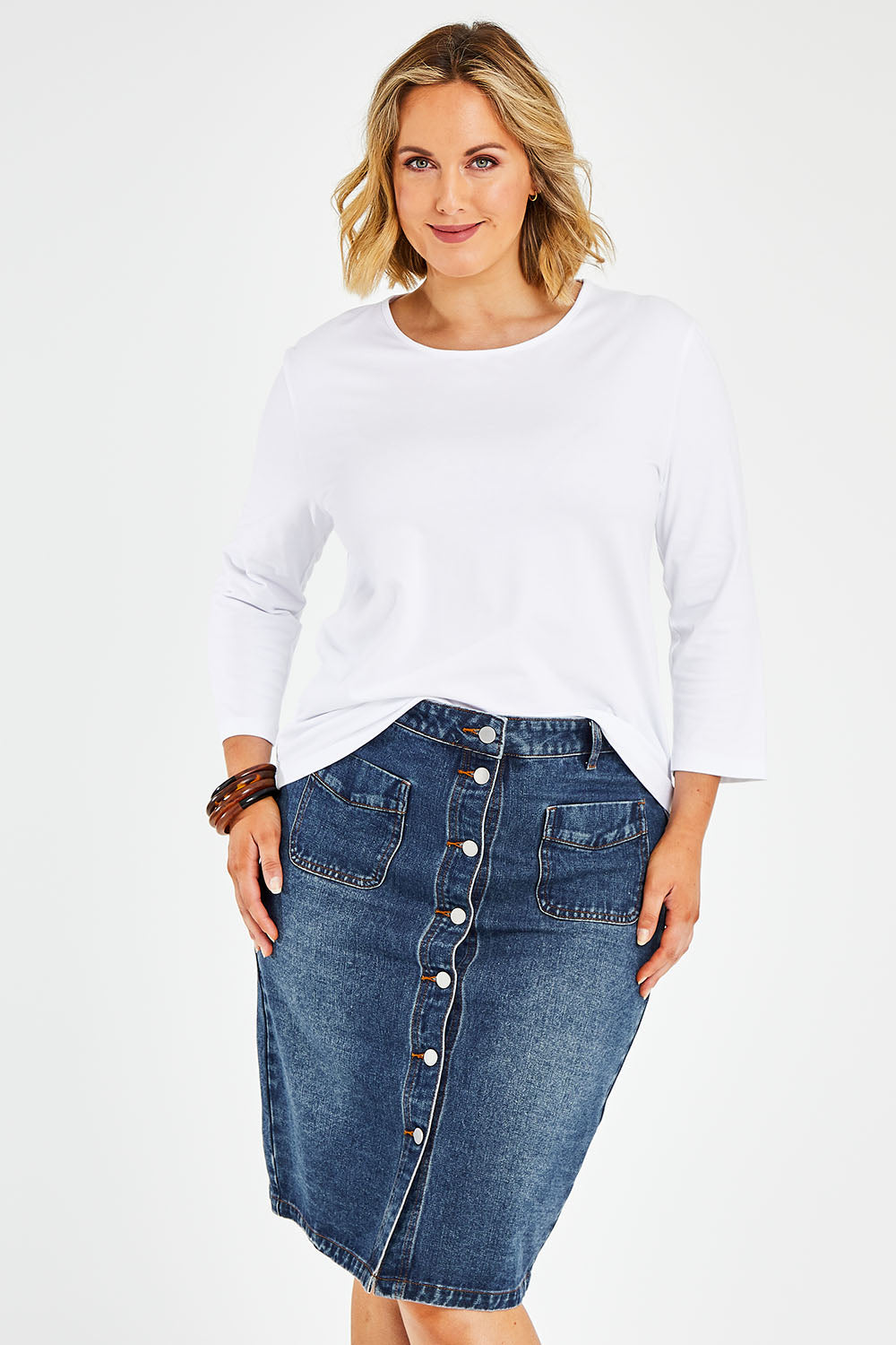 Model Jess wearing size 14 of The Midi Button Up Skirt in colour Darkdenim (Blue), from the front, cropped image