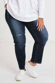 Model Alexis wearing size 16 of The Distressed Boyfriend Jean in colour Darkdenim (Blue), from the front, cropped image