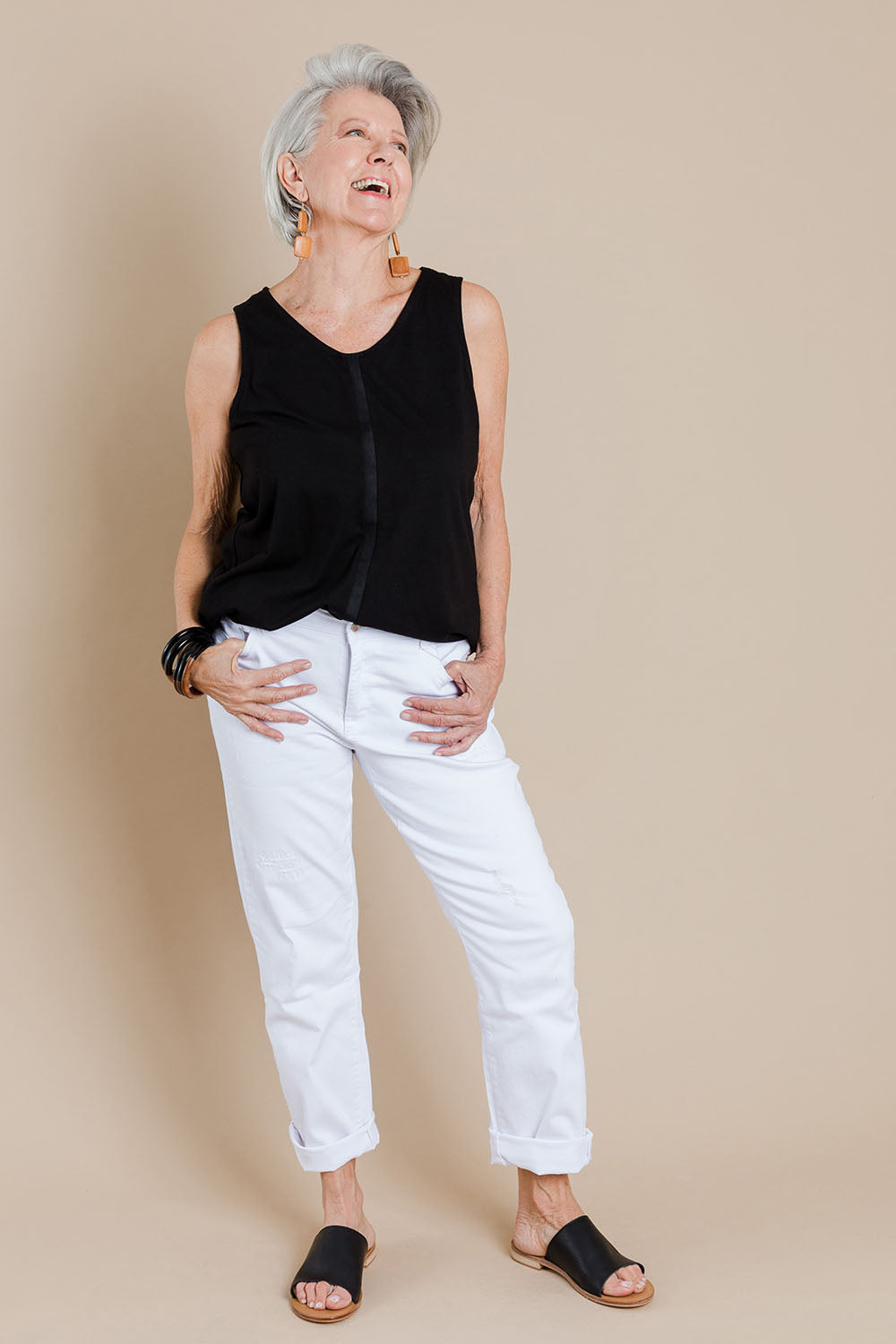Model Elise wearing size 10 of The Distressed Boyfriend Jean in colour White (White), from the front, showing the whole outfit