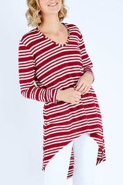 Model Chelsea wearing size 10 of The V Neck Hi Low Top in colour Redstripe (Red), from the front, cropped image