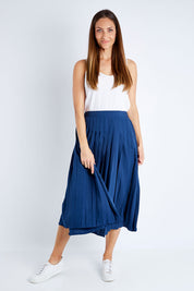 Model Anna wearing size 10 of The Pleated Skirt in colour Navy (Blue), from the front, showing the whole outfit
