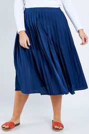 Model Fiona wearing size 16 of The Pleated Skirt in colour Navy (Blue), from the front, cropped image