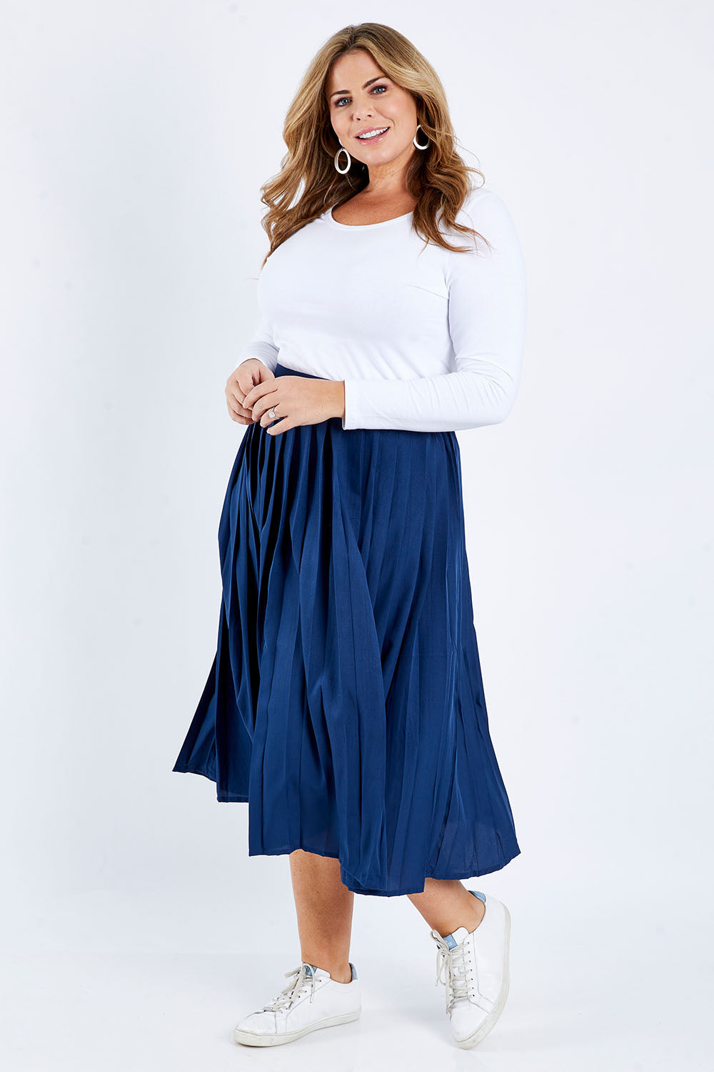 Model Fiona wearing size 16 of The Pleated Skirt in colour Navy (Blue), from the front, showing the whole outfit