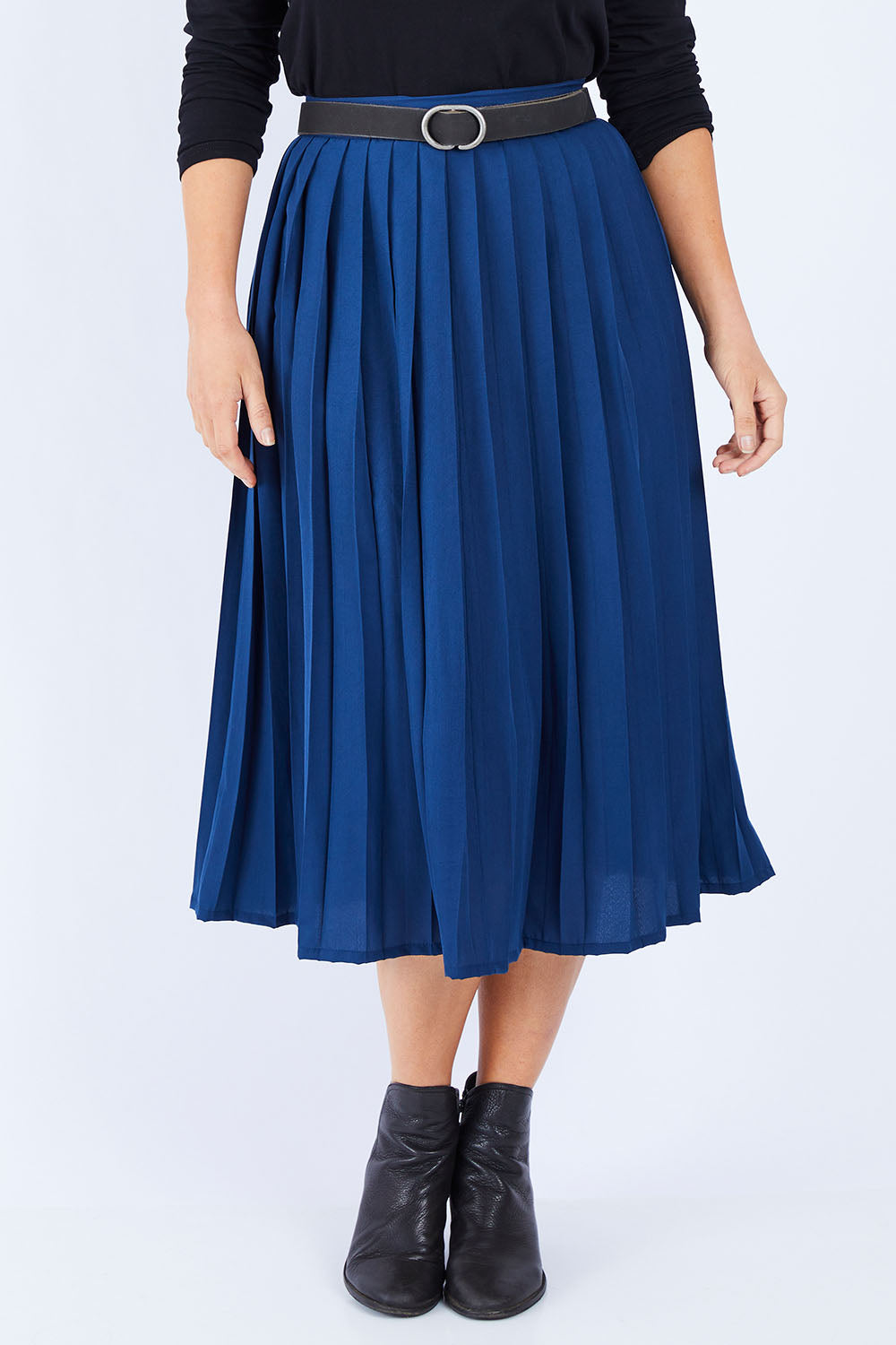 Model Laura wearing size 14 of The Pleated Skirt in colour Navy (Blue), from the front, cropped image