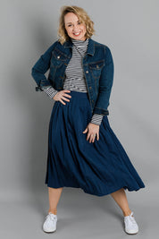 Model Steph wearing size 10 of The Pleated Skirt in colour Navy (Blue), from the front, showing the whole outfit