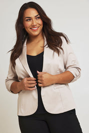 Model Ashleigh wearing size 16 of The Everyday Blazer in colour Stone, from the front, cropped image