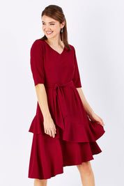 Model Rebecca wearing size 10 of The Layer Midi Dress in colour DeepRed (Red), from the front, cropped image