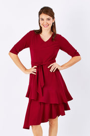 Model Rebecca wearing size 10 of The Layer Midi Dress in colour DeepRed (Red), from the front, cropped image