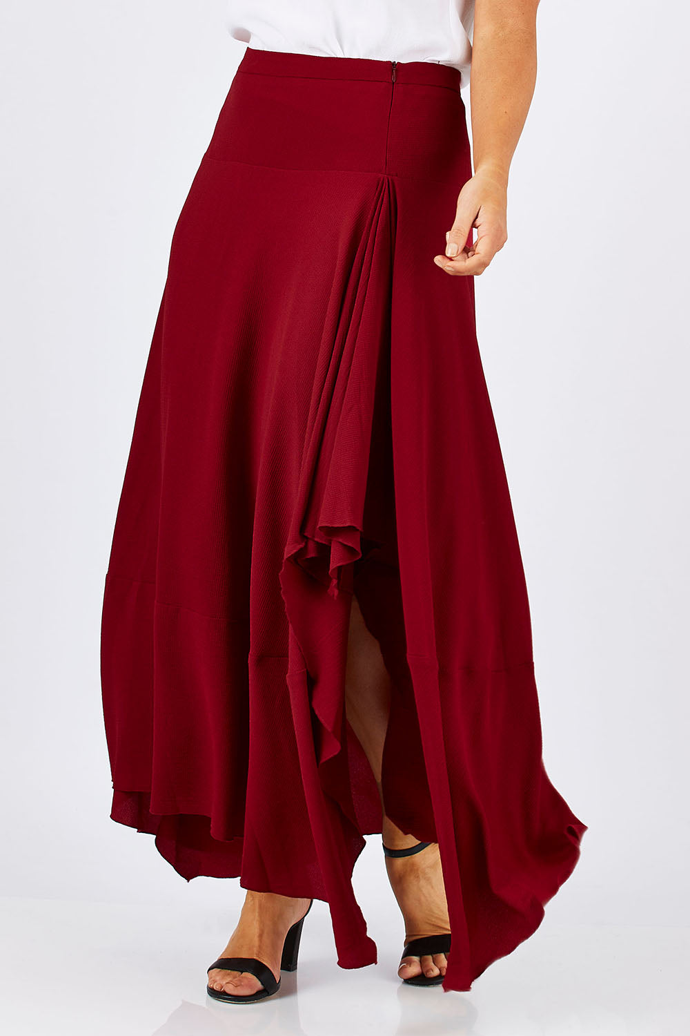 Model Laura wearing size 12 of The Flowy Skirt in colour Apple (Red), from the front, cropped image