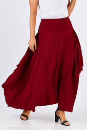 Model Laura wearing size 12 of The Flowy Skirt in colour Apple (Red), from the front, cropped image
