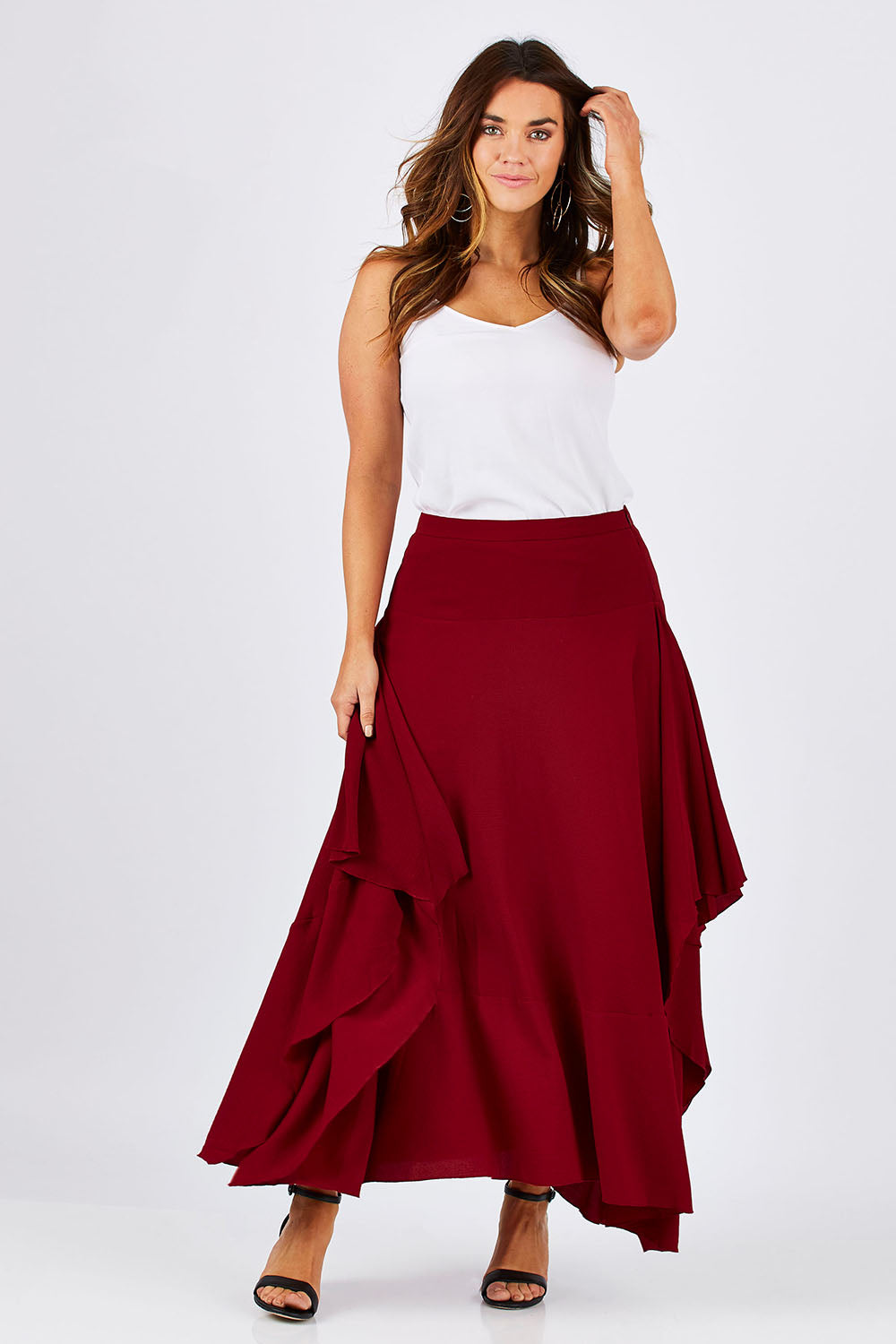Model Laura wearing size 12 of The Flowy Skirt in colour Apple (Red), from the front, showing the whole outfit