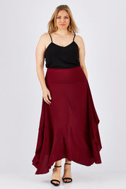 Model Ljubenka wearing size 18 of The Flowy Skirt in colour Apple (Red), from the front, showing the whole outfit