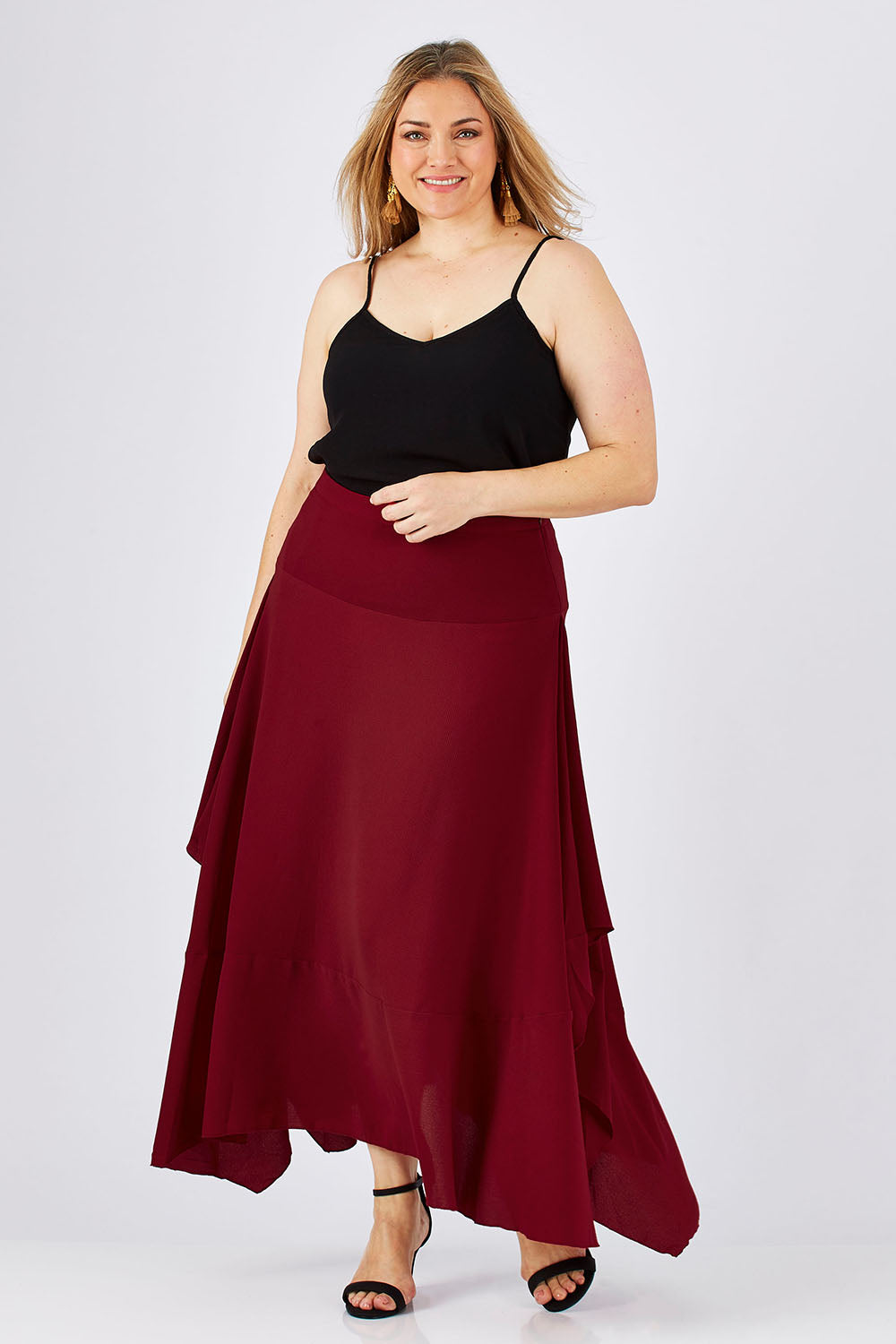 Model Ljubenka wearing size 18 of The Flowy Skirt in colour Apple (Red), from the front, showing the whole outfit