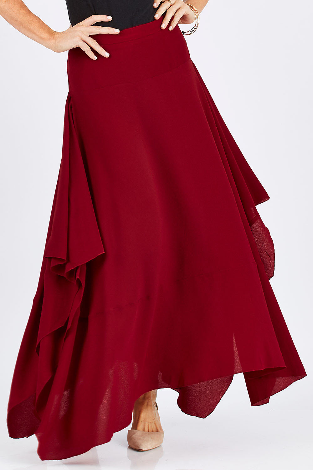 Model Monique wearing size 8 of The Flowy Skirt in colour Apple (Red), from the front, cropped image