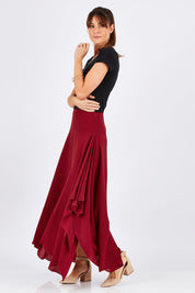 Model Monique wearing size 8 of The Flowy Skirt in colour Apple (Red), from the front, showing the whole outfit
