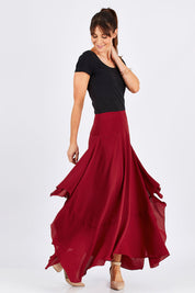 Model Monique wearing size 8 of The Flowy Skirt in colour Apple (Red), from the front, showing the whole outfit