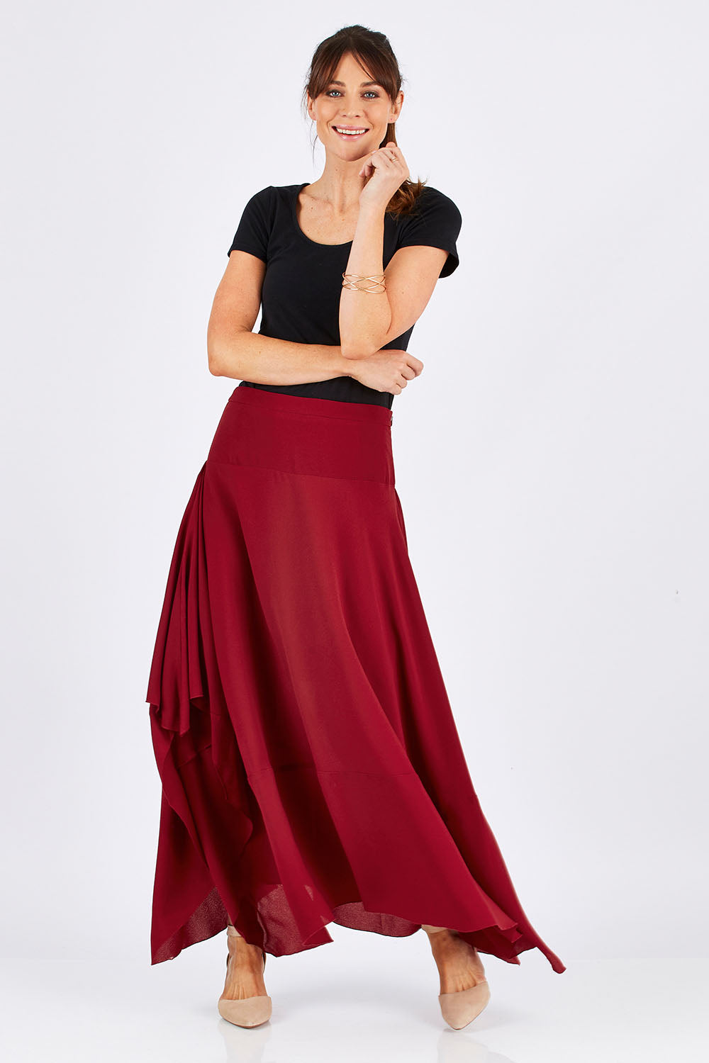 Model Monique wearing size 8 of The Flowy Skirt in colour Apple (Red), from the front, showing the whole outfit