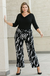 Model Fiona wearing size 16 of The Printed Travel Pant in colour Abstract (Black), from the front, showing the whole outfit