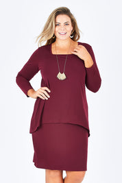 Model Fiona wearing size 16 of The Long Rita Dress in colour Port (Purple), from the front, cropped image