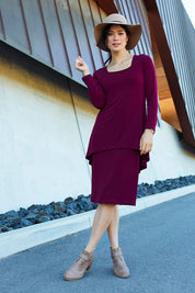 Model Miranda wearing size 10 of The Long Rita Dress in colour Port (Purple), from the front, showing the whole outfit