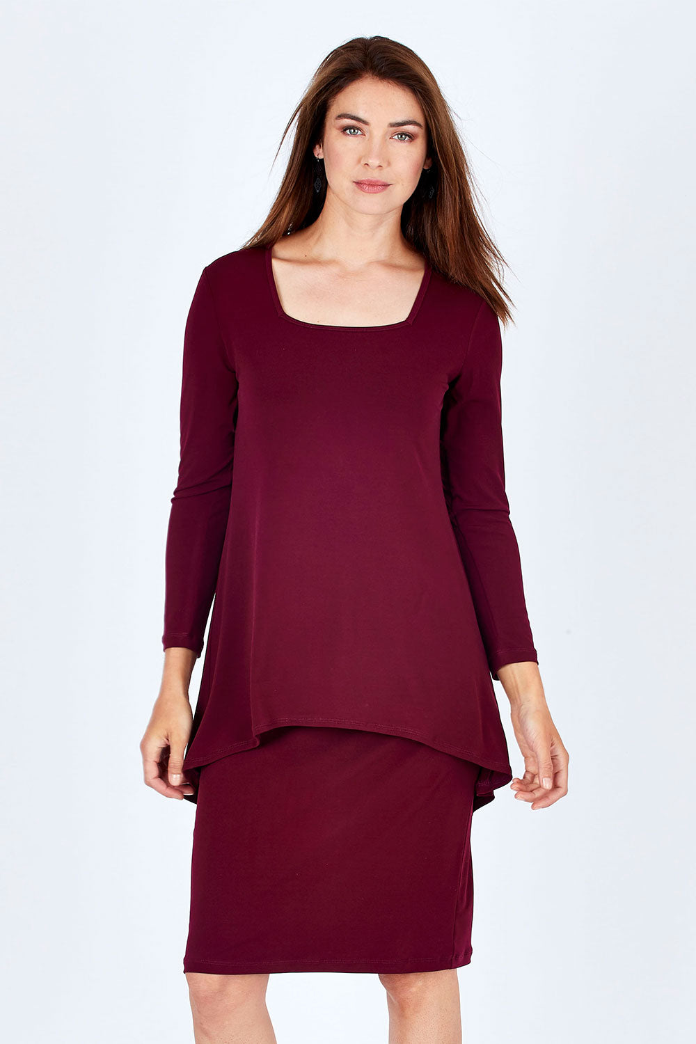 Model Rebecca wearing size 10 of The Long Rita Dress in colour Port (Purple), from the front, cropped image
