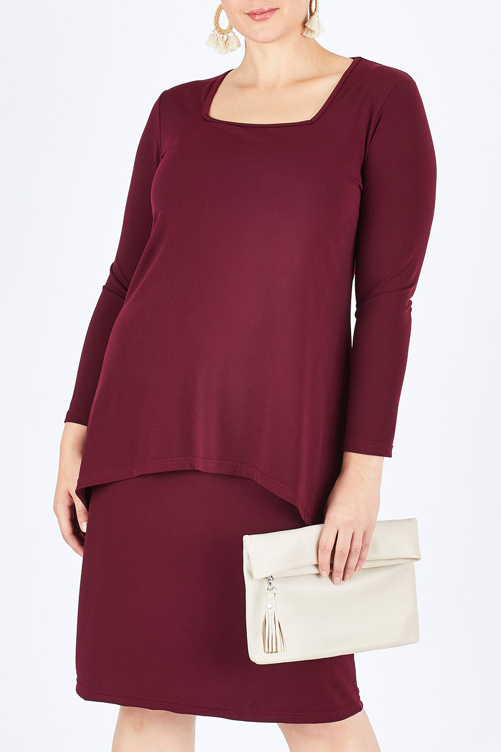 Model Stefania wearing size 14 of The Long Rita Dress in colour Port (Purple), from the front, cropped image