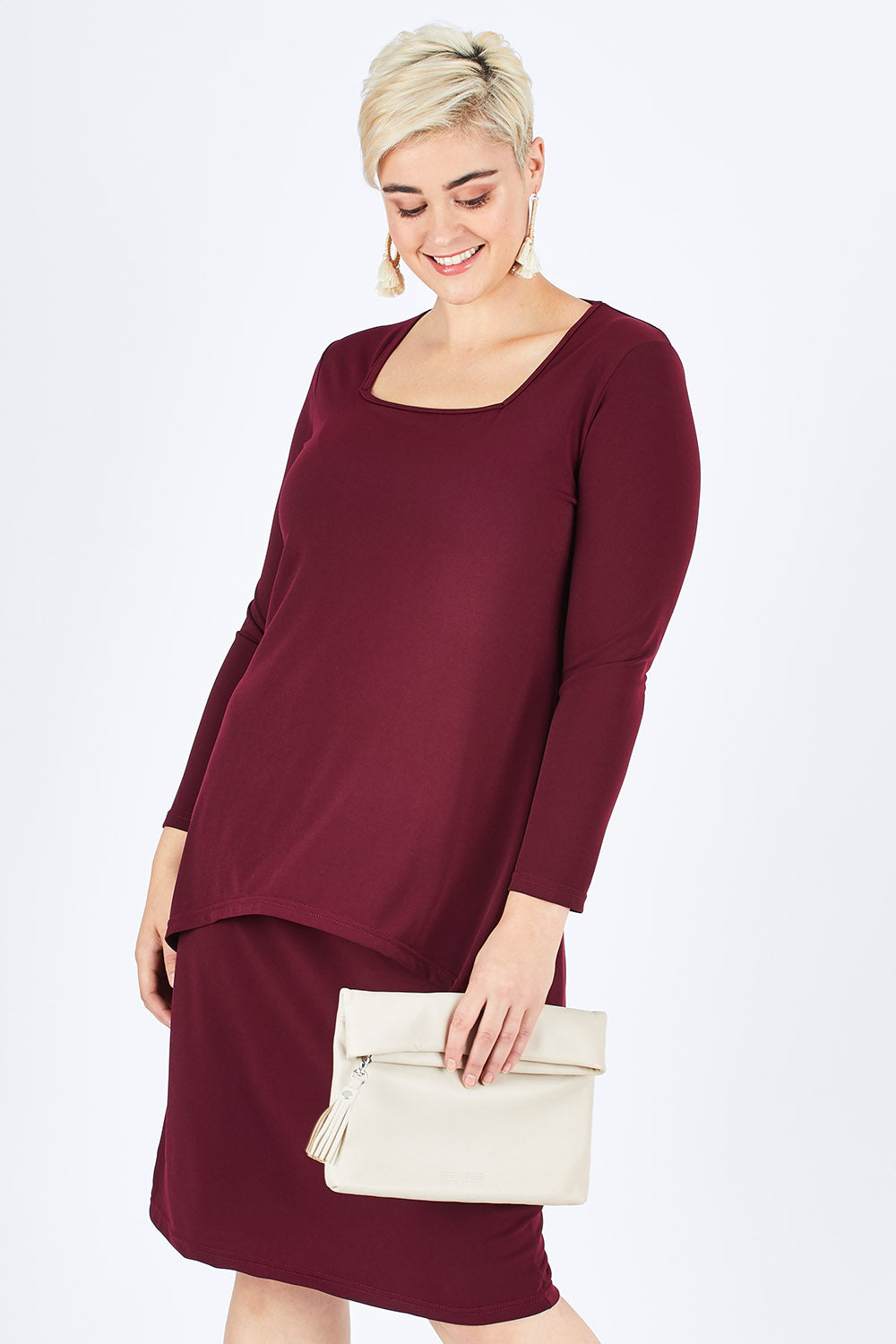 Model Stefania wearing size 14 of The Long Rita Dress in colour Port (Purple), from the front, cropped image