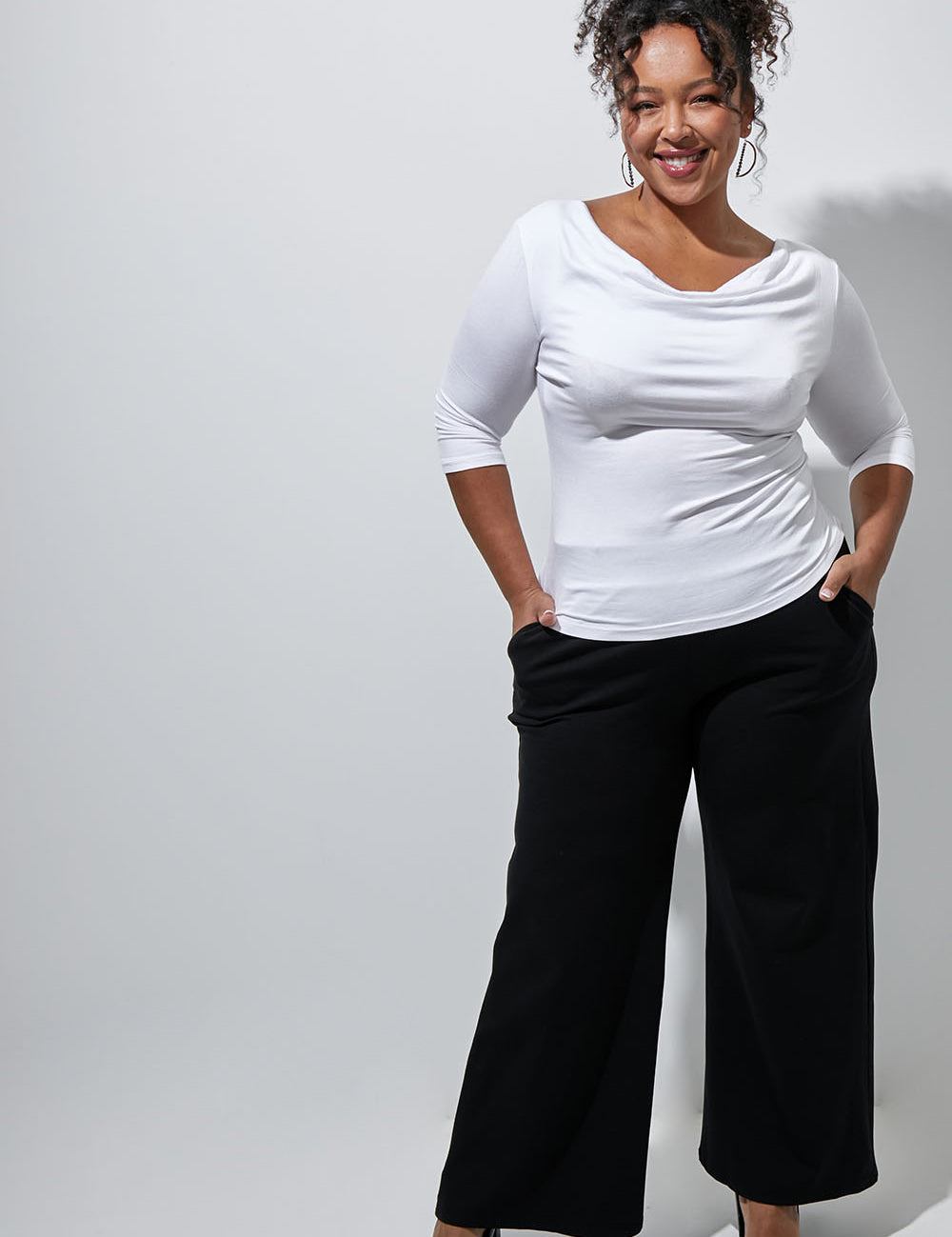 Model Alexis wearing size 16 of The Wide Leg Ponte Pant in colour Black (Black), from the front, showing the whole outfit