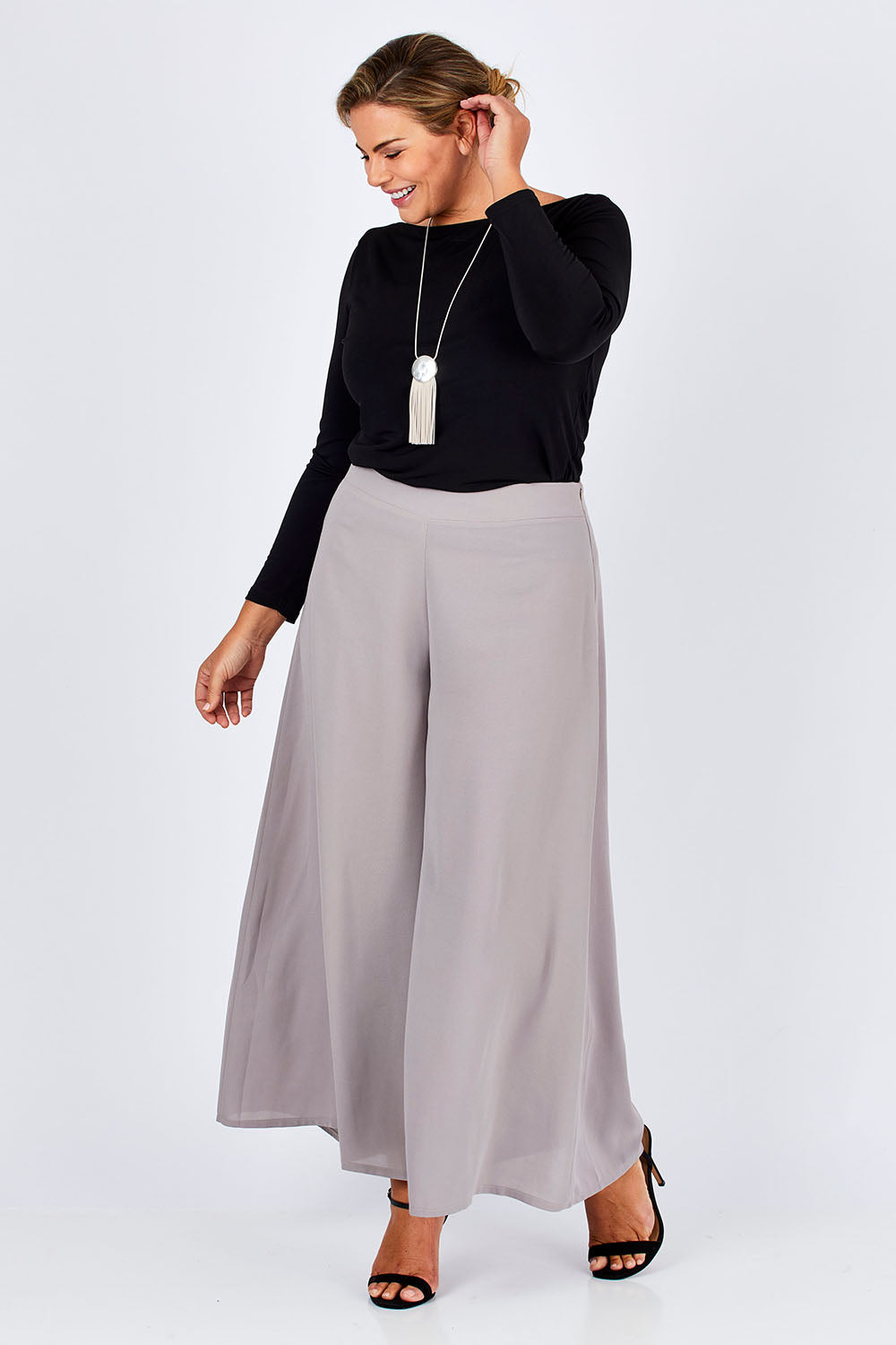 Model Fiona wearing size 16 of The Boat Neck Top in colour Black (Black), from the front, showing the whole outfit