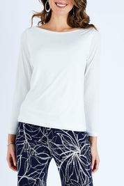Model Madeline wearing size 10 of The Boat Neck Top in colour Ivory (White), from the front, cropped image