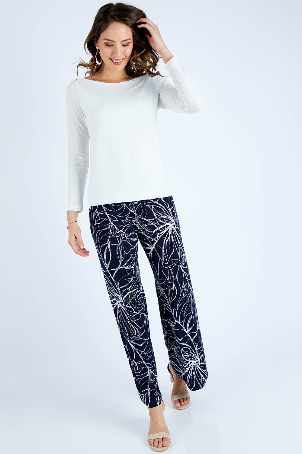 Model Madeline wearing size 10 of The Boat Neck Top in colour Ivory (White), from the front, showing the whole outfit