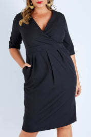 Model Fiona wearing size 16 of The Half Sleeve Tulip Dress in colour Black (Black), from the front, cropped image