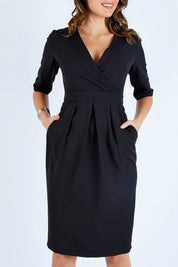 Model Madeline wearing size 10 of The Half Sleeve Tulip Dress in colour Black (Black), from the front, cropped image