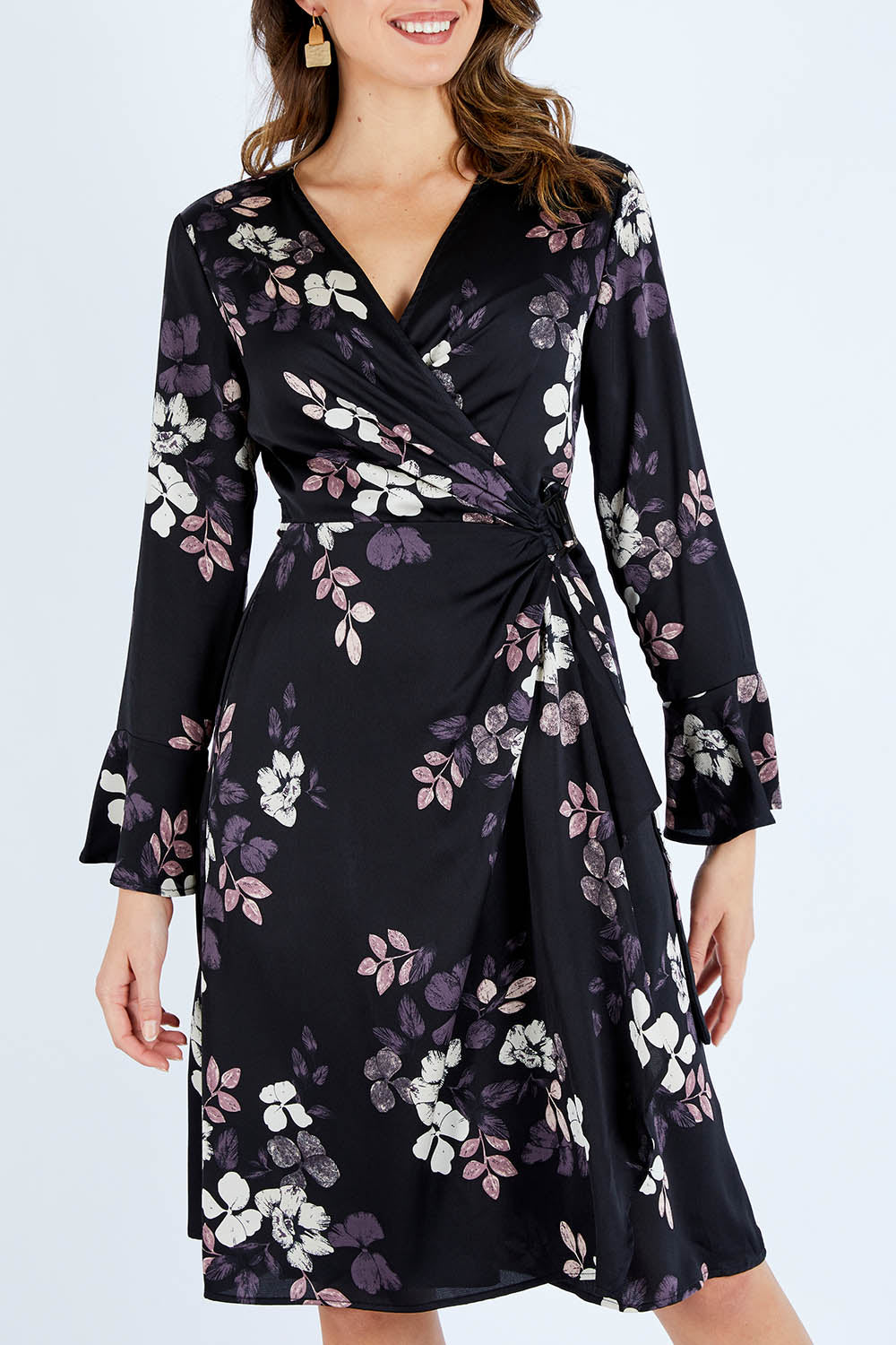 Model Madeline wearing size 10 of The Define Printed Wrap Dress in colour Floral (Black), from the front, cropped image