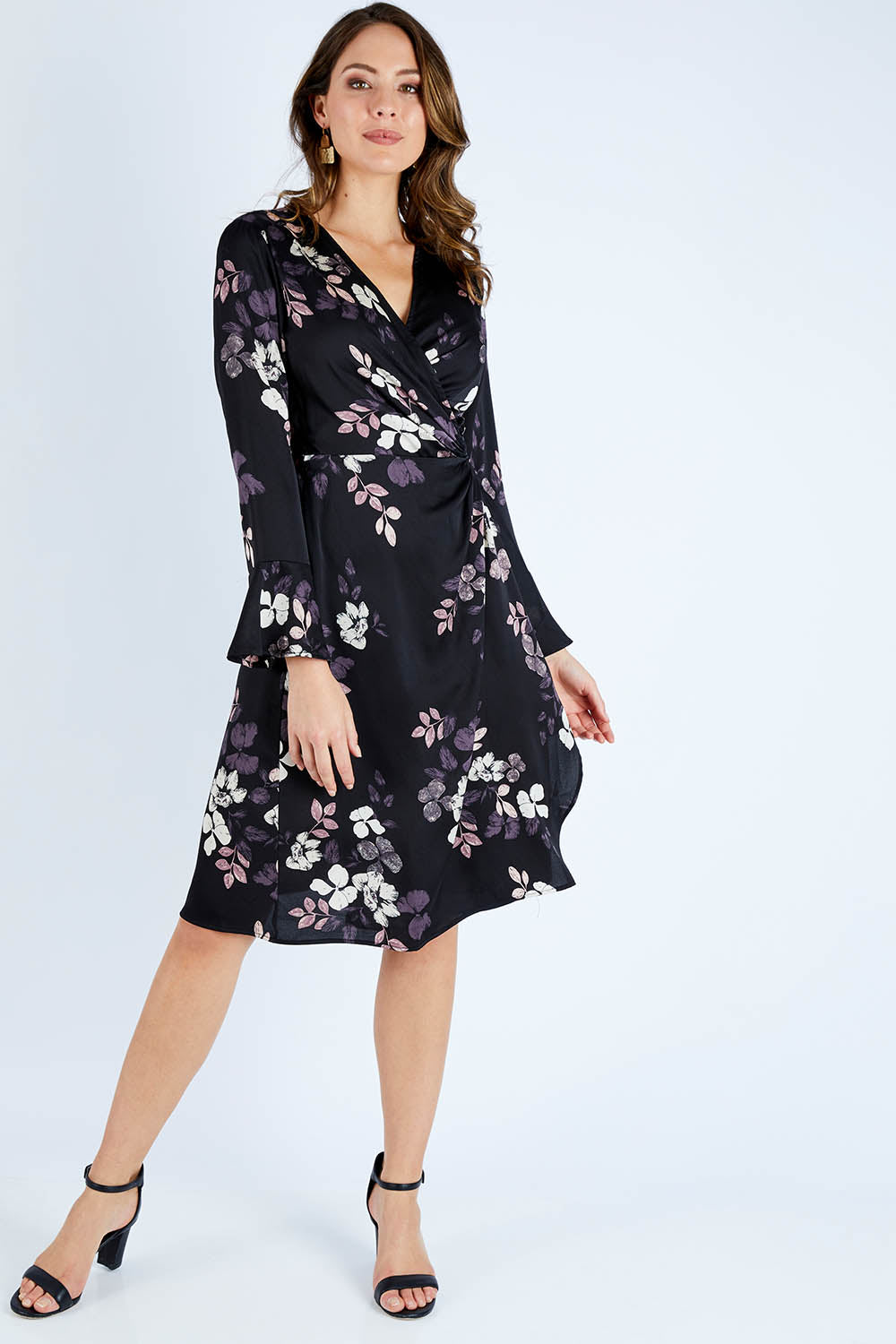 Model Madeline wearing size 10 of The Define Printed Wrap Dress in colour Floral (Black), from the front, showing the whole outfit